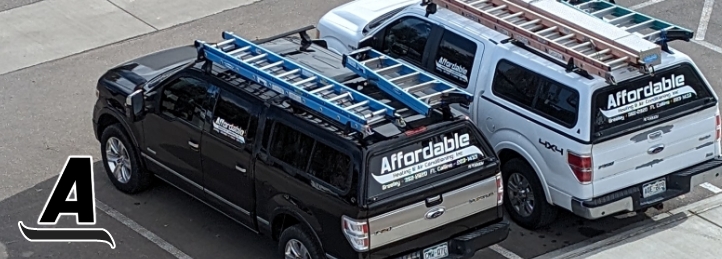 Two Affordable Heating & Air Conditioning trucks parked in a lot