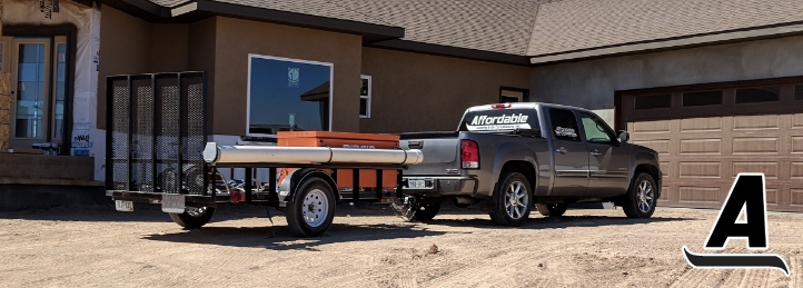 Truck with Affordable Heating & Air Conditioning logo towing a trailer parked in front of a house