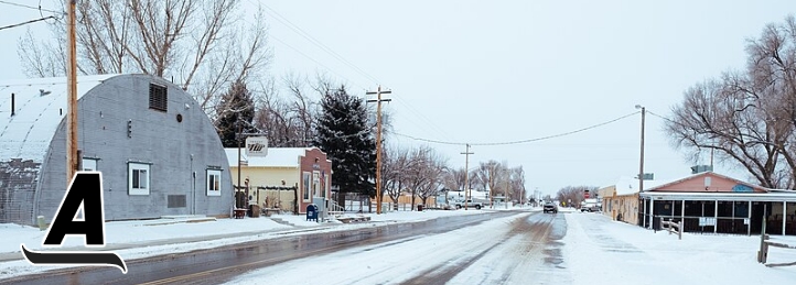 Photo of snowy buildings and road in Severance, CO